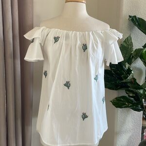 White cacti embroidered off the shoulder blouse.